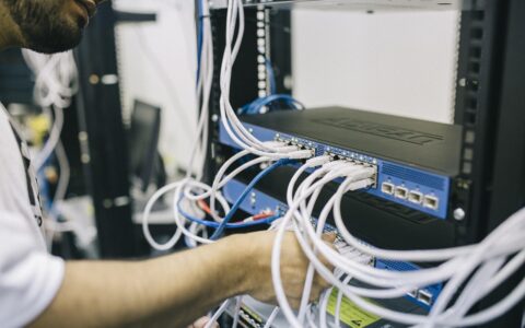 IT support engineer repairing network switch